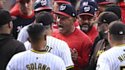 Washington Nationals bench coach Miguel Cairo (22) talks to San Diego Padres manager Mike Shildt (8) during a benches-clearing altercation in the first inning at Petco Park on June 25, 2024.