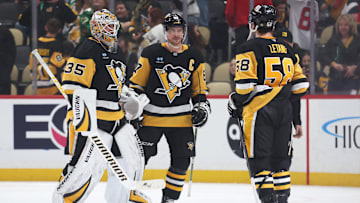 Mar 15, 2025; Pittsburgh, Pennsylvania, USA;  Pittsburgh Penguins goaltender Tristan Jarry (35) and center Sidney Crosby (87) and defenseman Kris Letang (58) celebrate after defeating the New Jersey Devils at PPG Paints Arena. Mandatory Credit: Charles LeClaire-Imagn Images