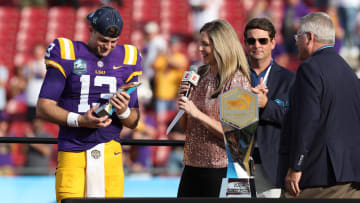 Jan 1, 2024; Tampa, FL, USA; LSU Tigers quarterback Garrett Nussmeier (13) is awarded the MVP award after beating the Wisconsin Badgers in the ReliaQuest Bowl at Raymond James Stadium. Mandatory Credit: Nathan Ray Seebeck-USA TODAY Sports