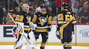 Mar 15, 2025; Pittsburgh, Pennsylvania, USA;  Pittsburgh Penguins goaltender Tristan Jarry (35) and center Sidney Crosby (87) and defenseman Kris Letang (58) celebrate after defeating the New Jersey Devils at PPG Paints Arena. Mandatory Credit: Charles LeClaire-Imagn Images