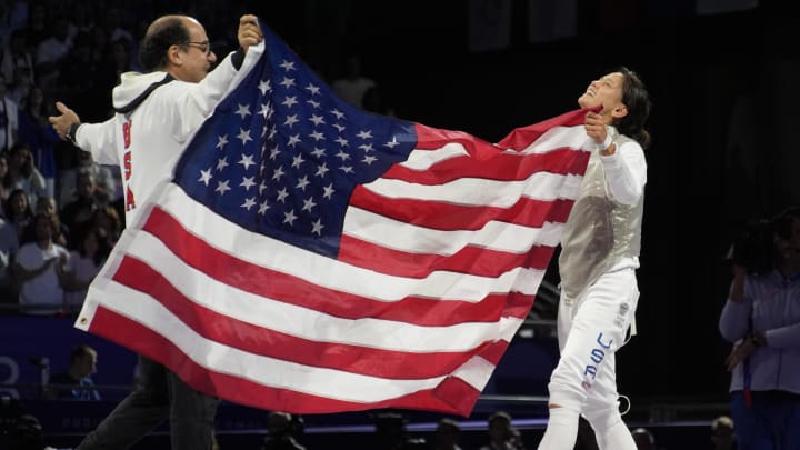 Jul 28, 2024; Paris, France;  Lee Kiefer (USA) celebrates with coach Amgad Khazbak after defeating Lauren Scruggs (USA) in a women's foil gold medal bout during the Paris 2024 Olympic Summer Games at Grand Palais. Mandatory Credit: Andrew P. Scott-USA TODAY Sports