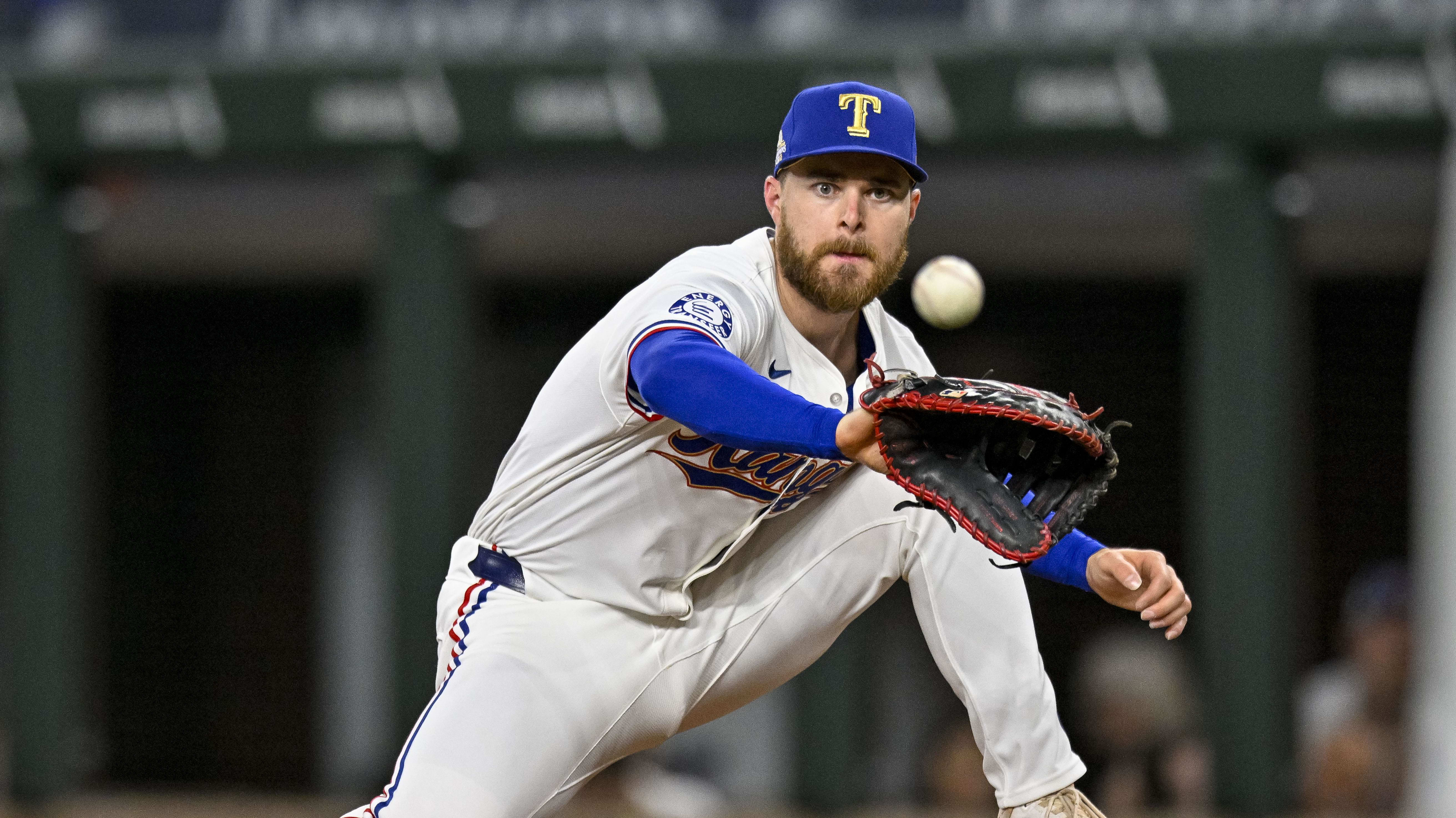 Apr 10, 2024; Arlington, Texas, USA; Texas Rangers first baseman Jared Walsh (21) fields a throw.