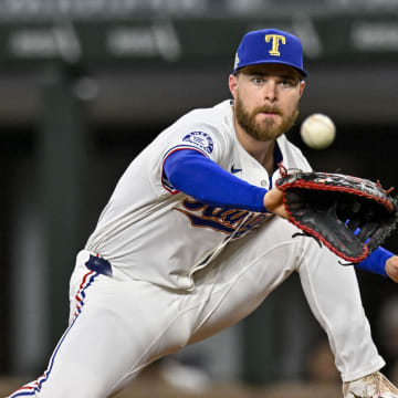 Apr 10, 2024; Arlington, Texas, USA; Texas Rangers first baseman Jared Walsh (21) fields a throw to first base during the fourth inning against the Oakland Athletics at Globe Life Field.