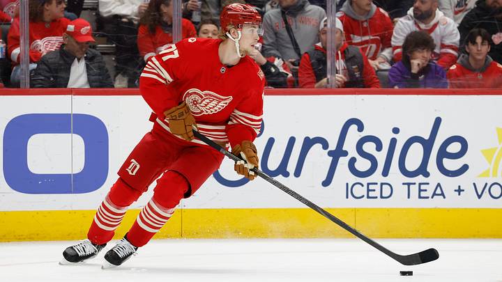 Mar 28, 2026; Detroit, Michigan, USA;  Detroit Red Wings defenseman Simon Edvinsson (77) skates with the puck in the first period against the Philadelphia Flyers at Little Caesars Arena. 