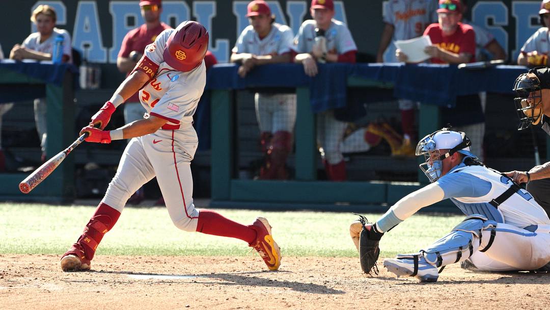 Jun 5, 2026; Chapel Hill, NC, USA;  USC Trojans catcher Augie Lopez  (24) puts the ball in play during the seventh inning against the North Carolina Tar Heels at Boshamer Stadium. Mandatory Credit: Zachary Taft-Imagn Images