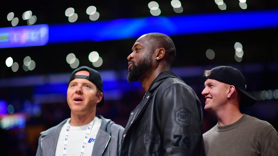 Nov 19, 2024; Los Angeles, California, USA; Utah Jazz minority owner Dwyane Wade with majority owner Ryan Smith (left) watch game action against the Los Angeles Lakers during the second half at Crypto.com Arena. Mandatory Credit: Gary A. Vasquez-Imagn Images
