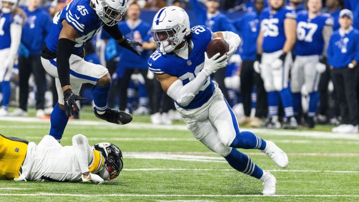 Dec 16, 2023; Indianapolis, Indiana, USA; Indianapolis Colts safety Nick Cross (20) runs with the ball after an interception in the first half against the Pittsburgh Steelers at Lucas Oil Stadium. Mandatory Credit: Trevor Ruszkowski-USA TODAY Sports