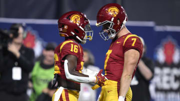 Dec 27, 2023; San Diego, CA, USA; USC Trojans wide receiver Tahj Washington (16) celebrates with quarterback Miller Moss (7) after a touchdown against the Louisville Cardinals during the first half at Petco Park. Mandatory Credit: Orlando Ramirez-USA TODAY Sports