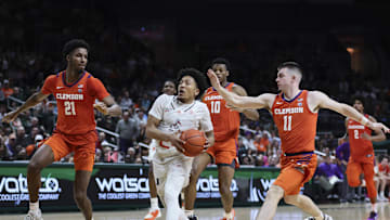 Jan 3, 2024; Coral Gables, Florida, USA; Miami Hurricanes guard Nijel Pack (24) drives to the basket ahead of Clemson Tigers guard Joseph Girard III (11) and forward Chauncey Wiggins (21) during the second half at Watsco Center. Mandatory Credit: Sam Navarro-Imagn Images
