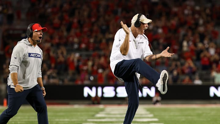 Sep 7, 2024; Tucson, Arizona, USA; Arizona Wildcats defensive line coach Joe Seumaloat and Arizona Wildcats defensive coordinator Duane Akina celebrates a tackle against Northern Arizona Lumberjacks during the fourth quarter Arizona Stadium. Mandatory Credit: Aryanna Frank-Imagn Images