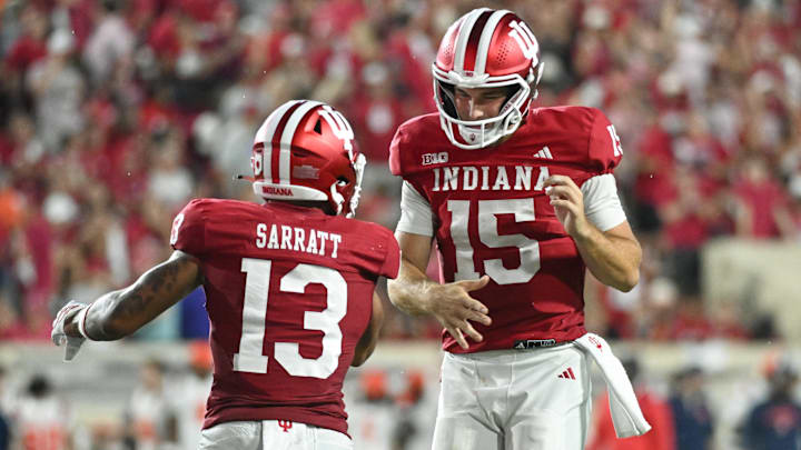 Sep 20, 2025; Bloomington, Indiana, USA; Indiana Hoosiers wide receiver Elijah Sarratt (13) and IIndiana Hoosiers quarterback Fernando Mendoza (15) celebrate after a touchdown during the second half against the Illinois Fighting Illini at Memorial Stadium. Mandatory Credit: Robert Goddin-Imagn Images