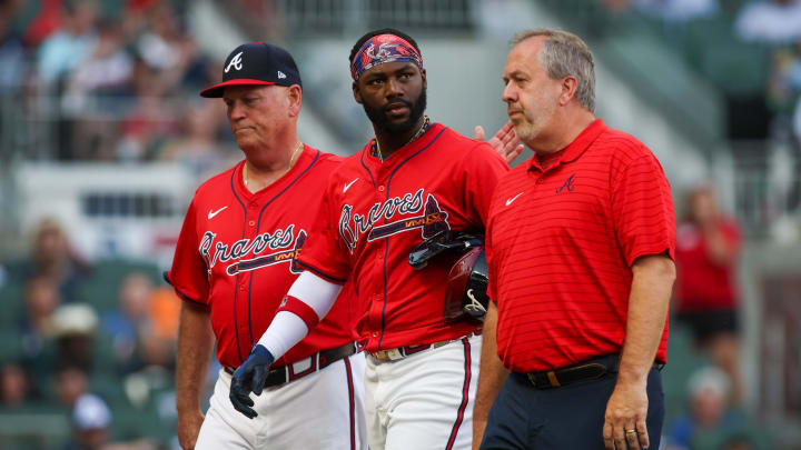 Jun 14, 2024; Atlanta, Georgia, USA; Atlanta Braves manager Brian Snitker (43) and center fielder Michael Harris II (23) walks off the field with assistant athletic trainer Jeff Stephenson after an injury against the Tampa Bay Rays in the first inning at Truist Park. Mandatory Credit: Brett Davis-USA TODAY Sports
