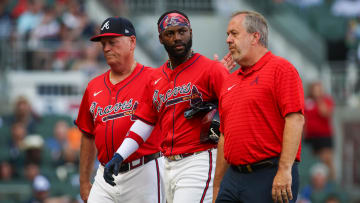 Jun 14, 2024; Atlanta, Georgia, USA; Atlanta Braves manager Brian Snitker (43) and center fielder Michael Harris II (23) walks off the field with assistant athletic trainer Jeff Stephenson after an injury against the Tampa Bay Rays in the first inning at Truist Park. Mandatory Credit: Brett Davis-USA TODAY Sports
