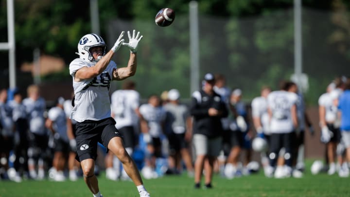 BYU wide receiver Cody Hagen (18) catches a pass at Fall camp