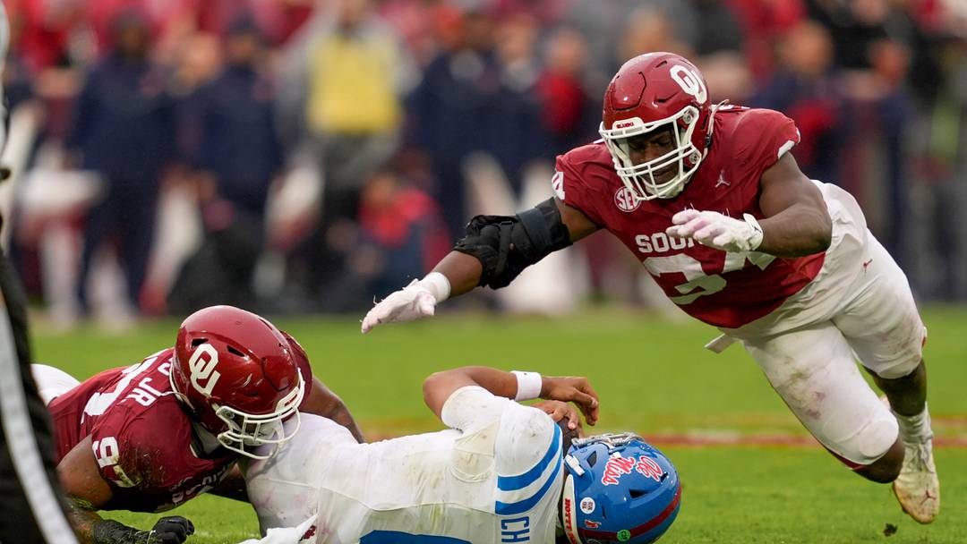 Oklahoma Sooners defensive lineman Marvin Jones Jr. brings down Ole Miss Rebels quarterback Trinidad Chambliss 