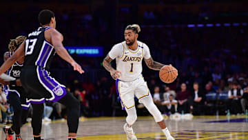 Dec 28, 2024; Los Angeles, California, USA; Los Angeles Lakers guard D'Angelo Russell (1) moves the ball against Sacramento Kings forward Keegan Murray (13) during the second half at Crypto.com Arena. Mandatory Credit: Gary A. Vasquez-Imagn Images