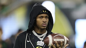 Nov 14, 2025; Eugene, Oregon, USA; Oregon Ducks wide receiver Dakorien Moore (1) watches teammates warm up before a game against the Minnesota Golden Gophers at Autzen Stadium. Mandatory Credit: Troy Wayrynen-Imagn Images