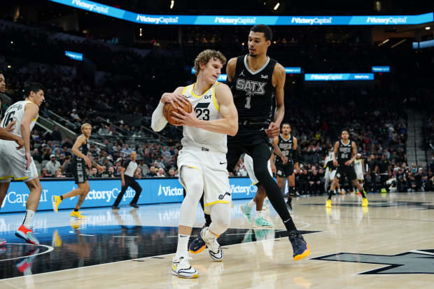 Utah Jazz forward Lauri Markkanen (23) keeps the ball from San Antonio Spurs center Victor Wembanyama (1). 