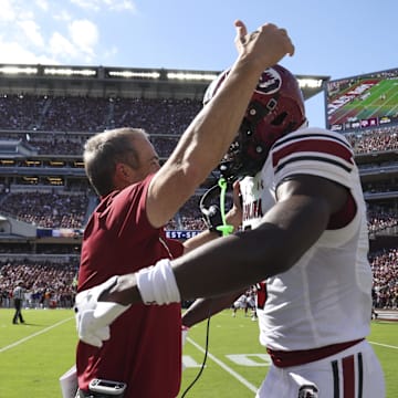 Nov 15, 2025; College Station, Texas, USA; South Carolina Gamecocks wide receiver Nyck Harbor (8) is embraced by head coach Shane Beamer after scoring a touchdown during the second quarter against the Texas A&M Aggies at Kyle Field. Mandatory Credit: Troy Taormina-Imagn Images