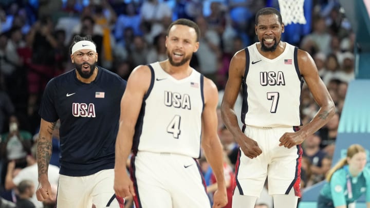 United States center Anthony Davis (left), guard Kevin Durant (7) and shooting guard Stephen Curry (4) celebrate during the second half against Serbia in a men's basketball semifinal game during the Paris 2024 Olympic Summer Games at Accor Arena. Mandatory Credit: