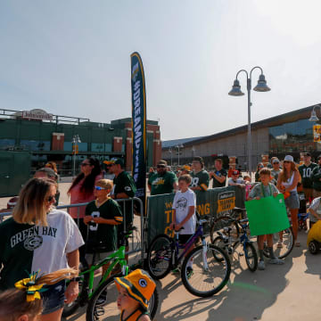 Children gather with their bicycles before the Dream Drive at the first day of Packers training camp on Monday.