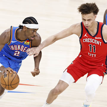 Apr 24, 2024; Oklahoma City, Oklahoma, USA; Oklahoma City Thunder guard Shai Gilgeous-Alexander (2) moves around New Orleans Pelicans guard Dyson Daniels (11) during the second half of game two of the first round for the 2024 NBA playoffs at Paycom Center.