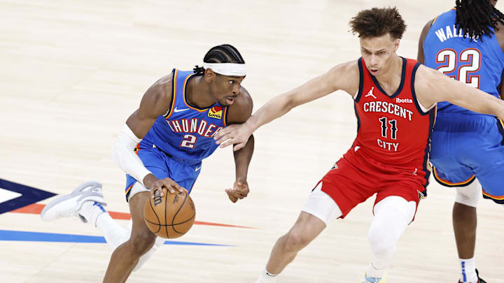 Apr 24, 2024; Oklahoma City, Oklahoma, USA; Oklahoma City Thunder guard Shai Gilgeous-Alexander (2) moves around New Orleans Pelicans guard Dyson Daniels (11) during the second half of game two of the first round for the 2024 NBA playoffs at Paycom Center.