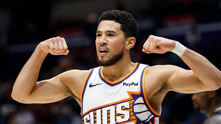 Phoenix Suns guard Devin Booker flexes during a game against the New Orleans Pelicans.