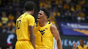 Feb 19, 2025; Morgantown, West Virginia, USA; West Virginia Mountaineers guard Joseph Yesufu (1) celebrates with West Virginia Mountaineers guard Sencire Harris (10) during the second half against the Cincinnati Bearcats at WVU Coliseum. Mandatory Credit: Ben Queen-Imagn Images