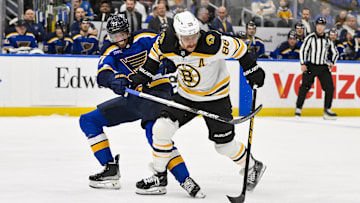 Nov 12, 2024; St. Louis, Missouri, USA;  Boston Bruins right wing David Pastrnak (88) skates against St. Louis Blues defenseman Pierre-Olivier Joseph (77) during the third period at Enterprise Center. Mandatory Credit: Jeff Curry-Imagn Images