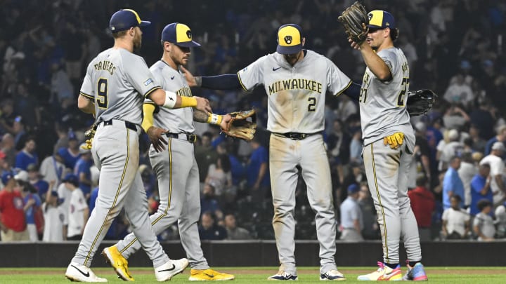 Jul 23, 2024; Chicago, Illinois, USA;  Milwaukee Brewers second baseman Brice Turang (2) reacts with first baseman Jake Bauers (9),  third baseman Joey Ortiz (3) and  shortstop Willy Adames (27) after the game against the Chicago Cubs at Wrigley Field. Mandatory Credit: Matt Marton-USA TODAY Sports