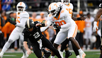 Nov 30, 2024; Nashville, Tennessee, USA;  Tennessee Volunteers defensive lineman Dominic Bailey (90) hits Vanderbilt Commodores quarterback Diego Pavia (2) as he passes the ball during the second half at FirstBank Stadium. Mandatory Credit: Steve Roberts-Imagn Images