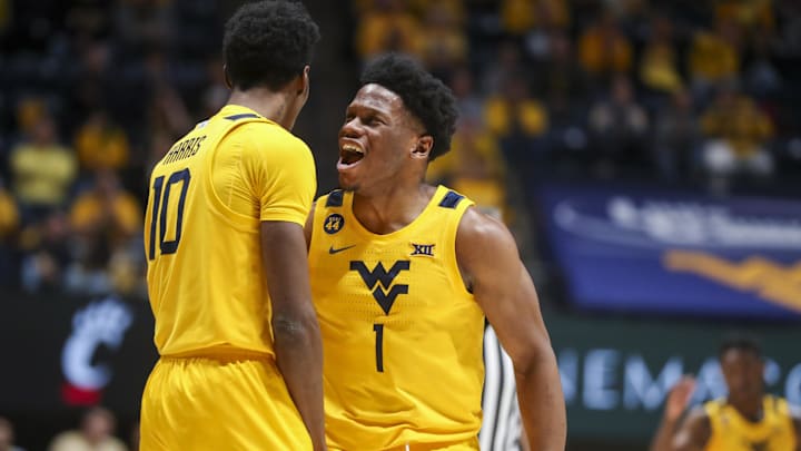 Feb 19, 2025; Morgantown, West Virginia, USA; West Virginia Mountaineers guard Joseph Yesufu (1) celebrates with West Virginia Mountaineers guard Sencire Harris (10) during the second half against the Cincinnati Bearcats at WVU Coliseum. Mandatory Credit: Ben Queen-Imagn Images