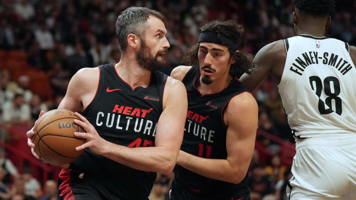 Nov 16, 2023; Miami, Florida, USA;  Miami Heat forward Kevin Love (42) grabs a rebound over Brooklyn Nets forward Dorian Finney-Smith (28) as guard Jaime Jaquez Jr. (11) follows on the play in the second half at Kaseya Center. Mandatory Credit: Jim Rassol-USA TODAY Sports