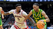 Mar 23, 2025; Seattle, WA, USA;  Arizona Wildcats guard KJ Lewis (5) defends against Oregon Ducks guard Keeshawn Barthelemy (9) in the second half at Climate Pledge Arena. Mandatory Credit: Stephen Brashear-Imagn Images