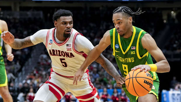 Mar 23, 2025; Seattle, WA, USA;  Arizona Wildcats guard KJ Lewis (5) defends against Oregon Ducks guard Keeshawn Barthelemy (