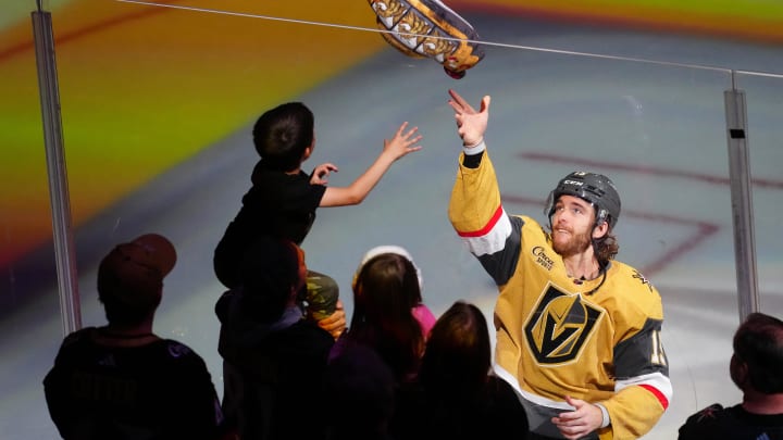 May 3, 2024; Las Vegas, Nevada, USA; Vegas Golden Knights defenseman Noah Hanifin (15) tosses a souvenir to a fan after being named First Star of the Game as the Golden Knights defeated the Dallas Stars 2-0 in game six of the first round of the 2024 Stanley Cup Playoffs at T-Mobile Arena. Mandatory Credit: Stephen R. Sylvanie-USA TODAY Sports