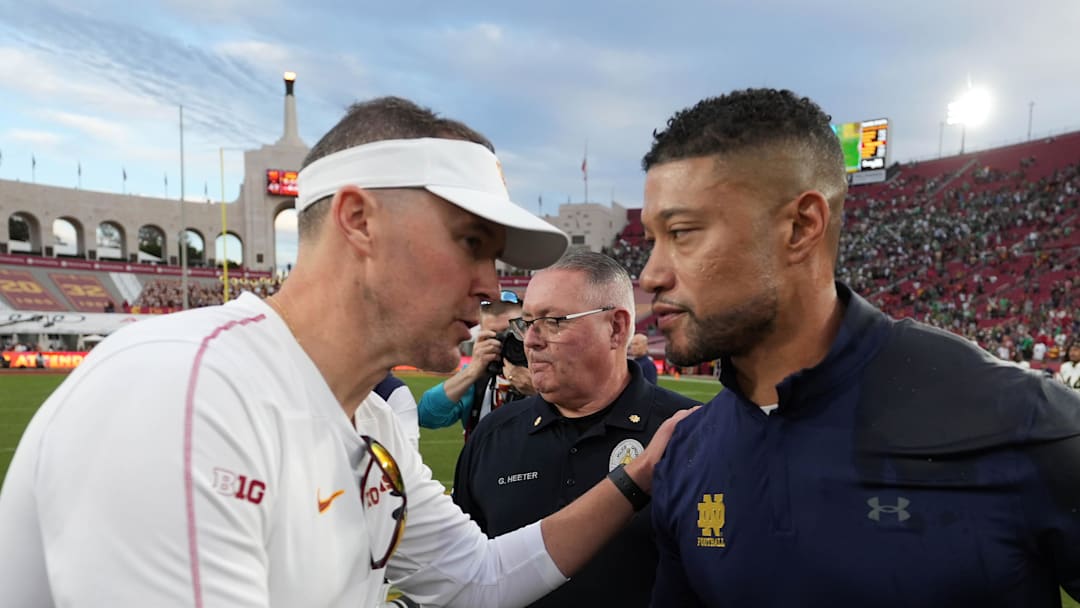 Nov 30, 2024; Los Angeles, California, USA; Southern California Trojans head coach Lincoln Riley and Notre Dame Fighting Irish head coach Marcus Freeman shake hands after the game at United Airlines Field at Los Angeles Memorial Coliseum. 