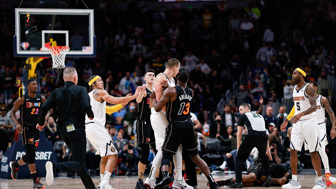 Nov 8, 2021; Denver, Colorado, USA; Miami Heat forward Markieff Morris (8) lies on the ground after a play with Denver Nuggets center Nikola Jokic (15) as guard Tyler Herro (14) and center Bam Adebayo (13) and forward Aaron Gordon (50) react as head coach Michael Malone runs to interject in the fourth quarter at Ball Arena. Mandatory Credit: Isaiah J. Downing-Imagn Images
