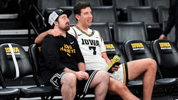 Iowa’s Alvaro Folgueiras (7) sits with a team manager during the Iowa men’s basketball team media day Oct. 15, 2025 at Carver-Hawkeye Arena in Iowa City, Iowa.