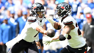 Sep 8, 2024; Indianapolis, Indiana, USA; Houston Texans quarterback C.J. Stroud (7) hands the ball off to Houston Texans running back Joe Mixon (28) during the second quarter at Lucas Oil Stadium. Mandatory Credit: Marc Lebryk-Imagn Images