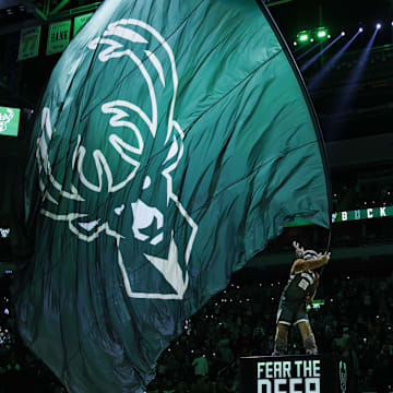Oct 26, 2023; Milwaukee, Wisconsin, USA;  Milwaukee Bucks mascot Bango waves a flag with the Milwaukee Bucks logo prior to the game agains the Philadelphia 76ers at Fiserv Forum. Mandatory Credit: Jeff Hanisch-Imagn Images