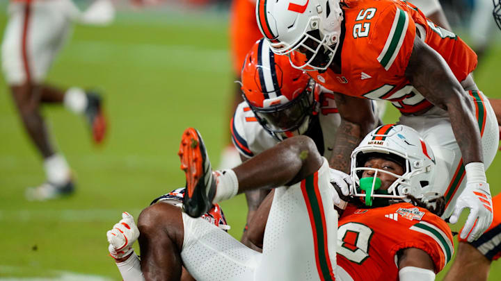 Nov 8, 2025; Miami Gardens, Florida, USA; Miami Hurricanes wide receiver Malachi Toney (10) is tackled after a punt return against the Syracuse Orange during the third quarter at Hard Rock Stadium. Mandatory Credit: Jeff Romance-Imagn Images