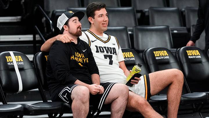 Iowa’s Alvaro Folgueiras (7) sits with a team manager during the Iowa men’s basketball team media day Oct. 15, 2025 at Carver-Hawkeye Arena in Iowa City, Iowa.