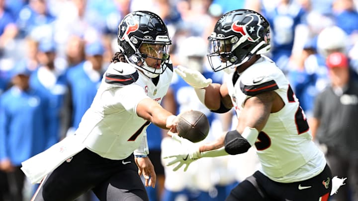 Sep 8, 2024; Indianapolis, Indiana, USA; Houston Texans quarterback C.J. Stroud (7) hands the ball off to Houston Texans running back Joe Mixon (28) during the second quarter at Lucas Oil Stadium. Mandatory Credit: Marc Lebryk-Imagn Images