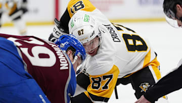 Mar 4, 2025; Denver, Colorado, USA; Pittsburgh Penguins center Sidney Crosby (87) and Colorado Avalanche center Nathan MacKinnon (29) take a face-off in the first period at Ball Arena. Mandatory Credit: Ron Chenoy-Imagn Images