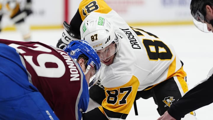 Mar 4, 2025; Denver, Colorado, USA; Pittsburgh Penguins center Sidney Crosby (87) and Colorado Avalanche center Nathan MacKinnon (29) take a face-off in the first period at Ball Arena. Mandatory Credit: Ron Chenoy-Imagn Images