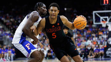 Nov 16, 2025; Jacksonville, Florida, USA; Miami Hurricanes forward Malik Reneau (5) drives to the basket at Florida Gators center Rueben Chinyelu (9) during the second half at VyStar Veterans Memorial Arena. Mandatory Credit: Matt Pendleton-Imagn Images