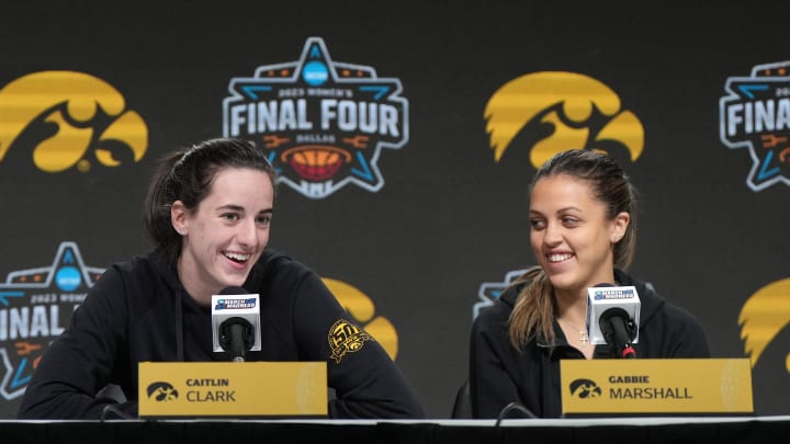 Mar 30, 2023; Dallas, TX, USA; Iowa Hawkeyes forward Monika Czinano (left) and guards Caitlin Clark (center) and Gabbie Marshall at press conference at the American Airlines Center. 