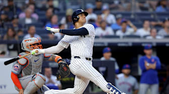 Jul 24, 2024; Bronx, New York, USA; New York Yankees right fielder Juan Soto (22) follows through on a solo home run against the New York Mets during the third inning at Yankee Stadium. Mandatory Credit: Brad Penner-USA TODAY Sports